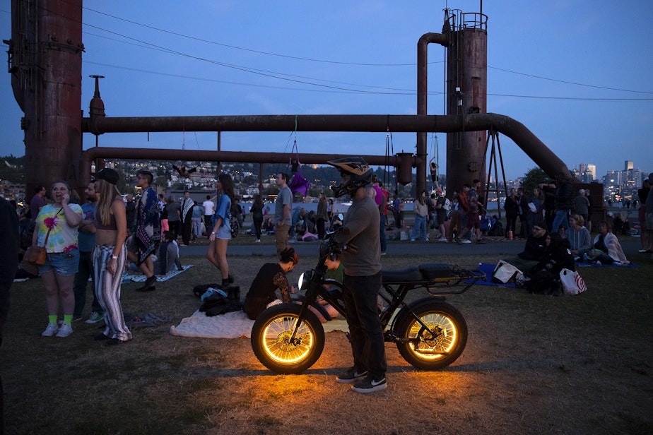 caption: Observers watch during the Levity Arts Seattle Summer Series on Friday, August 16, 2024, at Gasworks Park in Seattle.