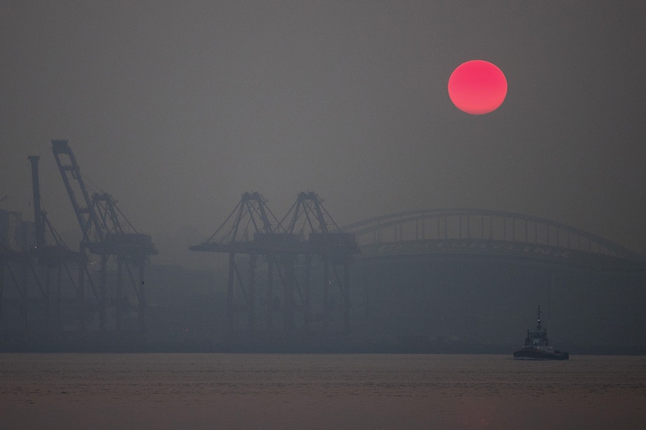 caption: The sun rises over Seattle as a massive plume of smoke from wildfires burning in California and Oregon makes it's way into the area on Friday, September 11, 2020, in Seattle.