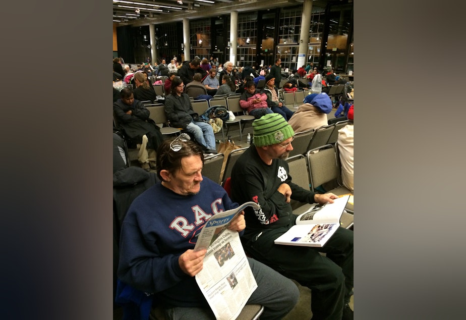 caption: Ken Peterson and Todd Rickdal at the free health clinic hosted at Key Arena Thursday morning.