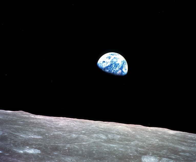 caption: This Dec. 24, 1968, file photo made available by NASA shows the Earth behind the surface of the moon during the Apollo 8 mission.