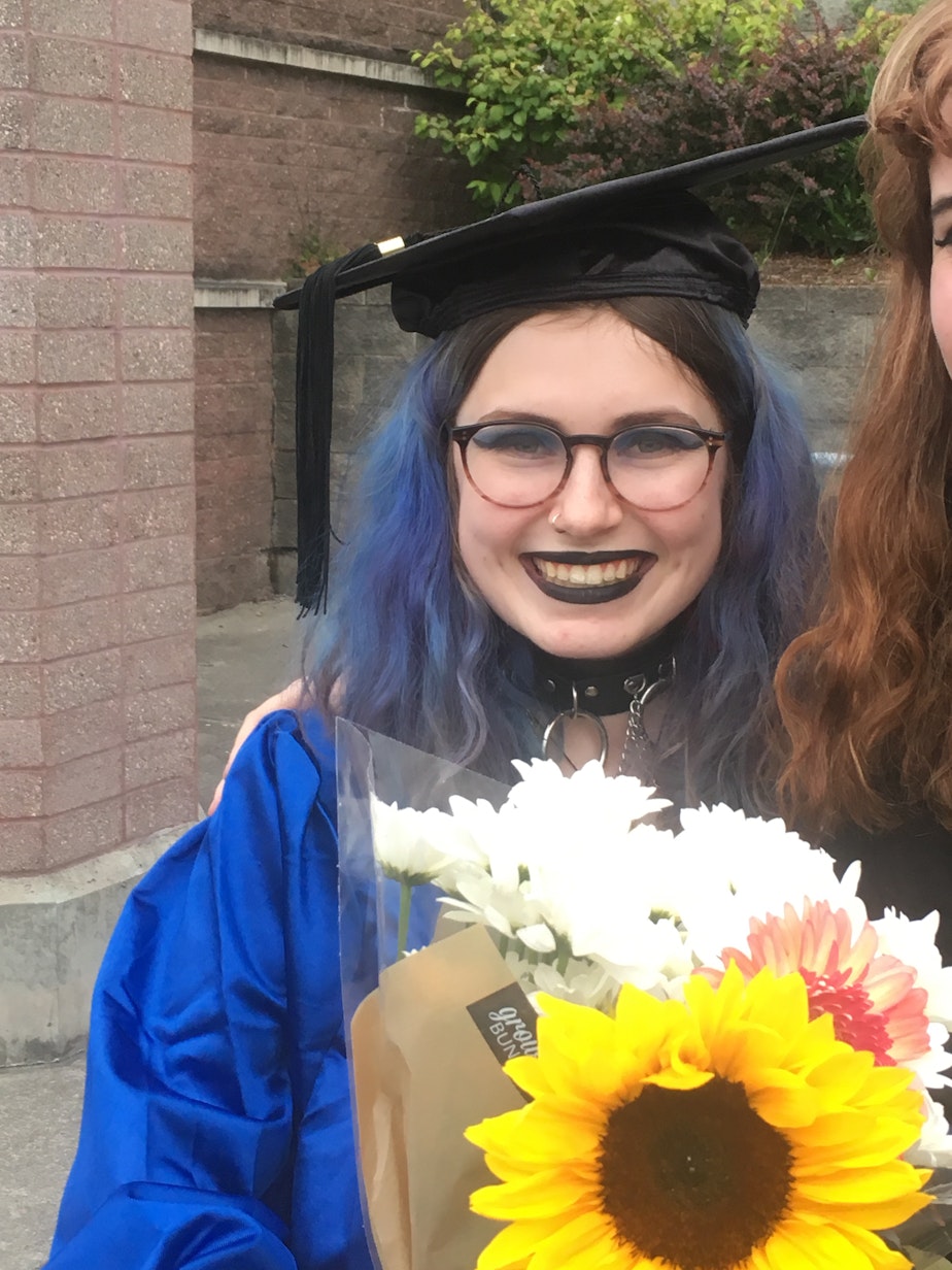caption: Mimi H. graduates from Nova High School.