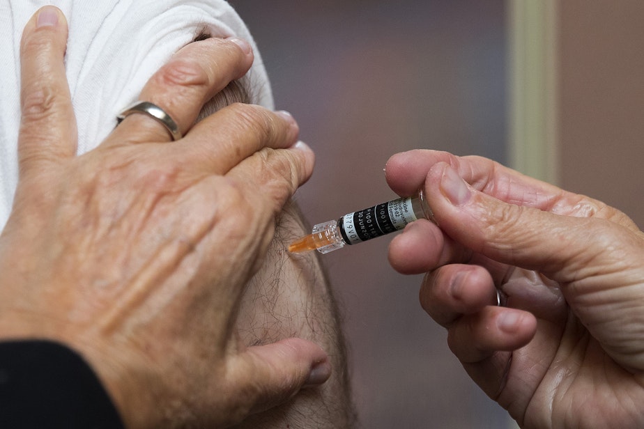 caption: Registered nurse Jeanice Smith administers a flu shot for Matthew Broadhead on Tuesday, October 1, 2019, at UW Tower in Seattle.