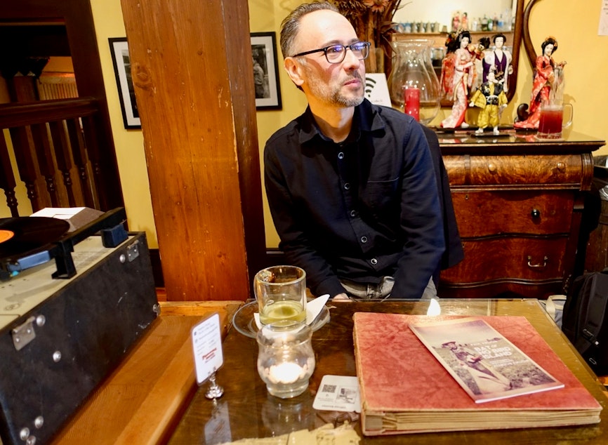 caption: Paul Kikuchi next to the Califone in the Panama Hotel Tea Room