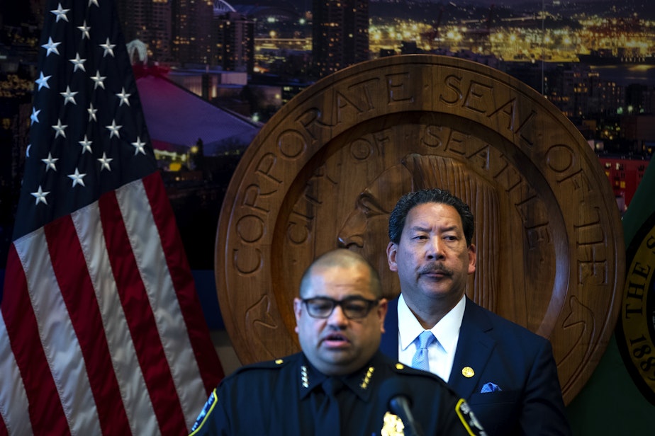 caption: Seattle mayor Bruce Harrell looks on as former Seattle police chief Adrian Diaz addresses members of the press during a press conference where it was announced that he’d be stepping down, on Wednesday, May 29, 2024, at City Hall in Seattle.