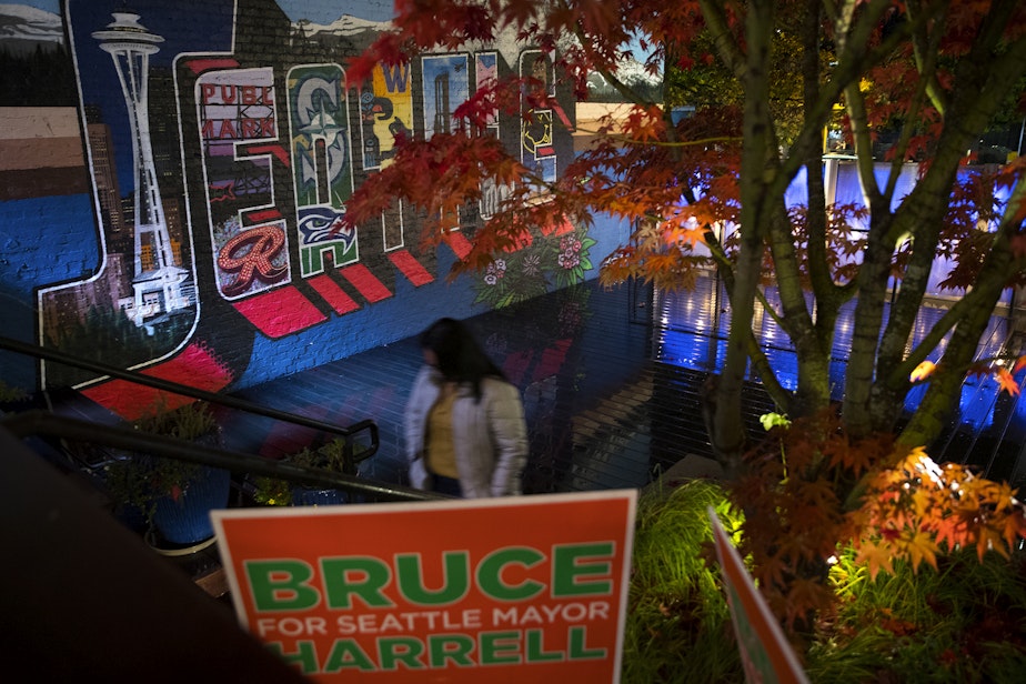 caption: A supporter of Bruce Harrell walks through an outdoor courtyard during an election night party for Harrell on Tuesday, November 2, 2021, at Block 41 on Bell Street in Seattle.