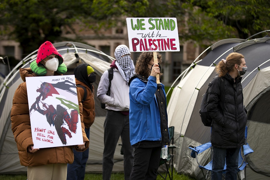 caption: University of Washington students set up what they are calling the UW Palestine Encampment on Monday, April 29, 2024, in Seattle.