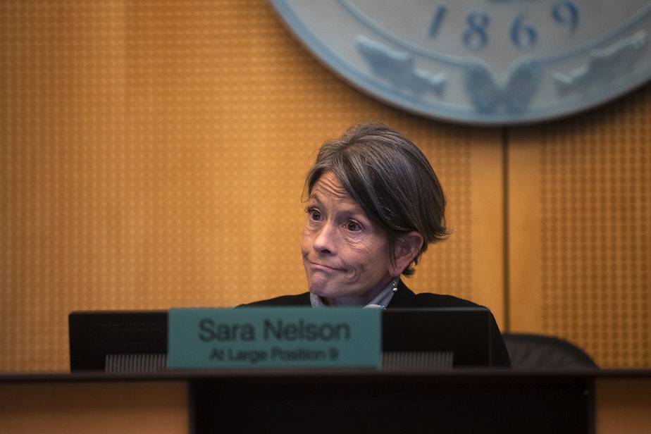 caption: Seattle City Council President Sara Nelson reacts during the public comment period of a city council meeting on Tuesday, Feb. 27, 2024, at Seattle City Hall.
