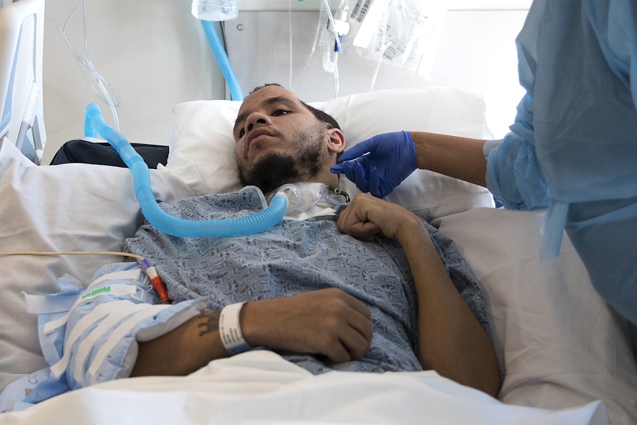caption: LaDonna Horne stands next to her son, DaShawn Horne, in his hospital room on Thursday, March 15, 2018, at Harborview Medical Center in Seattle.