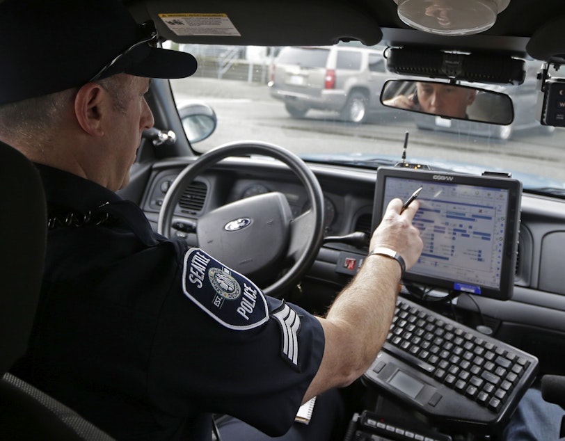 caption: In this photo taken March 2, 2016, Seattle Police officer Eric Pisconski, of SPD's crisis response unit, responds to a call in Seattle.