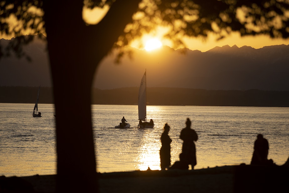 caption: The setting sun is shown at 7:45 p.m., on Tuesday, April 15, 2025, at Golden Gardens Park in Seattle.