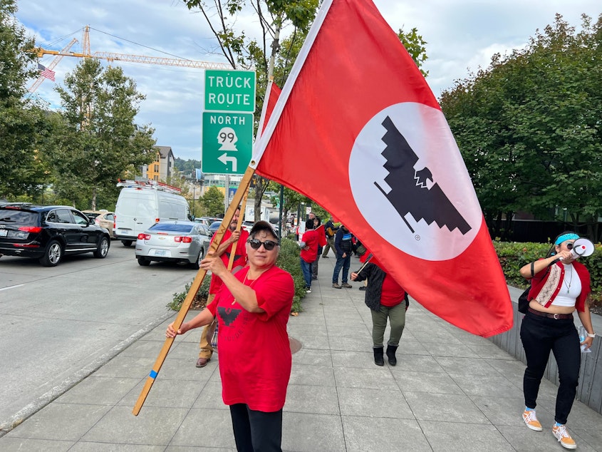 caption: Leandra Arreguin Valencia demonstrates in Seattle Thursday afternoon for the right for workers to unionize at Windmill Farms in Sunnyside, WA.
