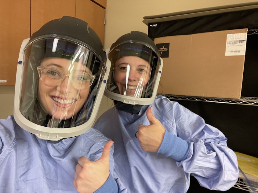 caption: Victoria Price (left) poses for a photo with a co-worker.