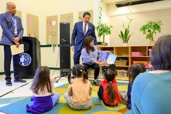caption: Seattle Mayor Bruce Harrell and Councilmember Maritza Rivera take turns reading "Under the Ramadan Moon" to a class of preschoolers at The Children's Center at Burke Gilman Gardens in North Seattle on March 14, 2025. 