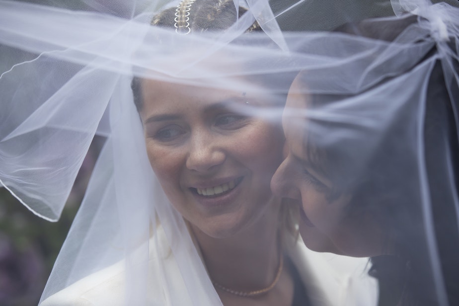 caption: Iryna, left, and Olena, smile for their photographer shortly after getting married on Saturday, April 8, 2023, at a home in Bellevue.