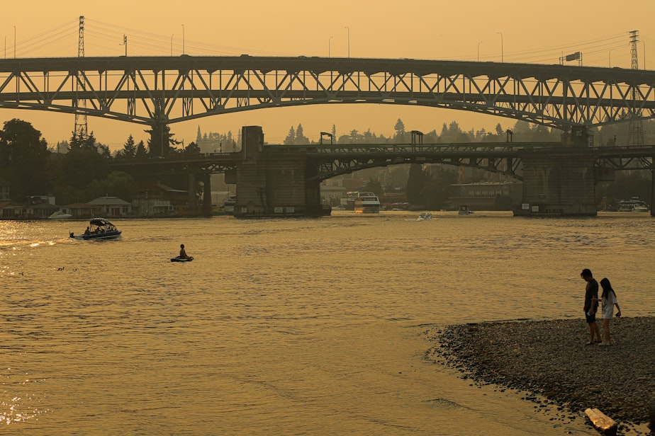 caption: Heavy smoke from wildfires blankets the region, as seen here from Fritz Hedges Waterway Park on Sunday, August 20, 2023, in Seattle.