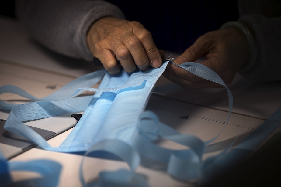 caption: Kaas Tailored employees sew masks on Monday, March 23, 2020, at the Kaas Tailored furniture factory in Mukilteo.