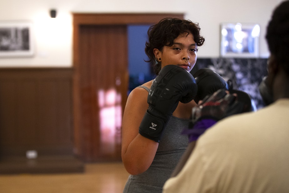 caption: Laura Garcia, 18, boxes during instructor Darnell Hill’s class on Wednesday, July 17, 2024, at Washington Hall in Seattle.