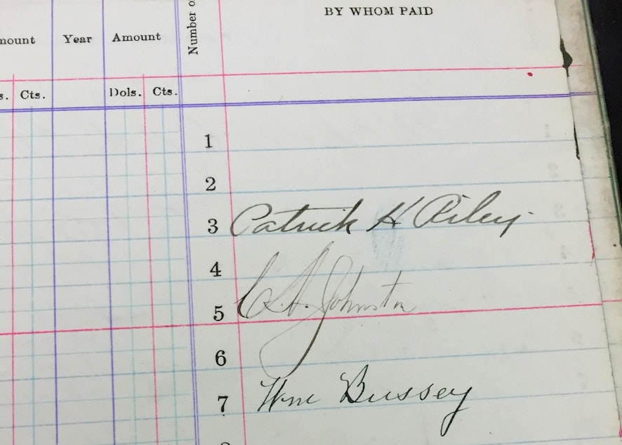 caption: Patrick Riley's (top) signature on the tax ledgers that homeowners would sign every year.