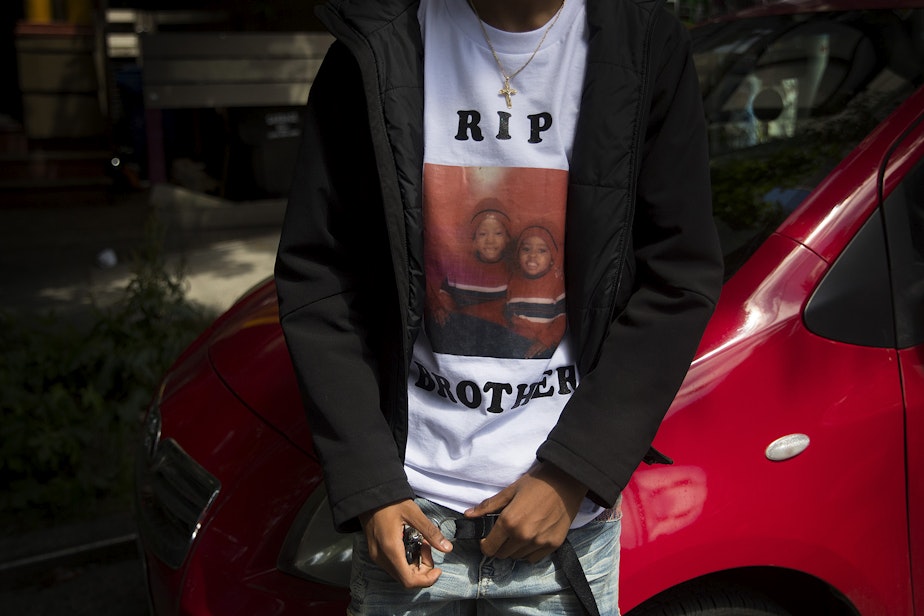 caption: The 17-year-old brother of 19-year-old Horace Lorenzo Daeshawn Anderson, who was shot and killed outside of the Capitol Hill Organized Protest zone on June 20, wears a t-shirt with an image of the two of them as children, on Monday, June 29, 2020, in Seattle.