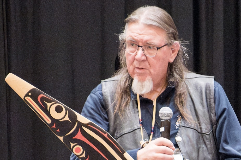 caption: Northwest Indian Fisheries Commission chair Ed Johnstone speaks at a ceremony marking the 50th anniversary of the Boldt decision, which recognized tribes’ rights to half of salmon harvests, in Feb. 2024.