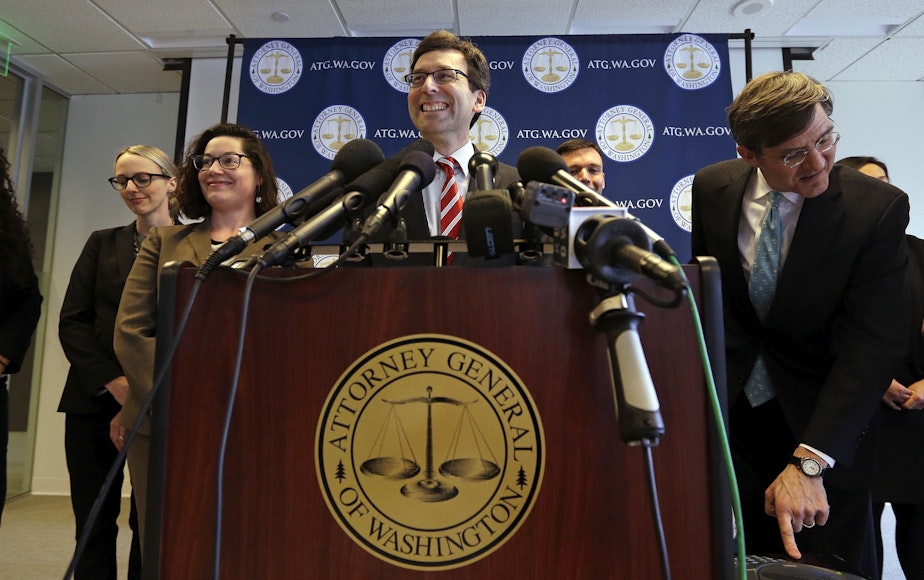 caption: Washington state Attorney General Bob Ferguson smiles during a news conference about President Trump's new executive order Monday, March 6, 2017, in Seattle.