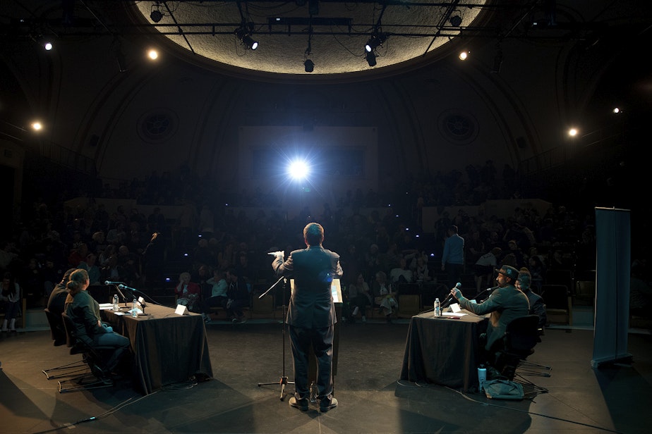 caption: Ross Reynolds moderates 'That's Debatable: The Homelessness Crisis is Killing Seattle' on Tuesday, October 29, 2019, at Langston Hughes Performing Arts Institute in Seattle.