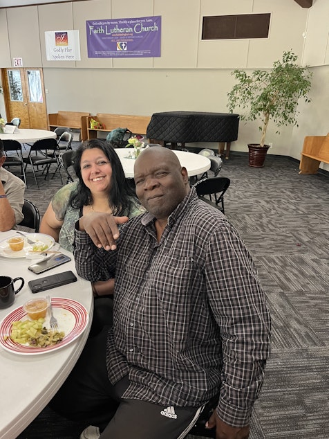 caption: Two Maple Alley regulars, Petra (left) and Larry (right), sit together for a meal.