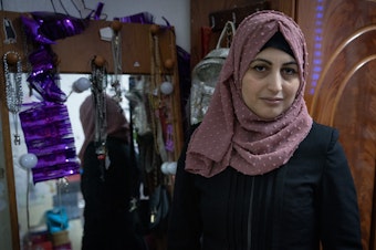 caption: Rimah Shahada poses in her daughter Aseel's bedroom in Qalandiya refugee camp in Ramallah, West Bank Nov. 22.