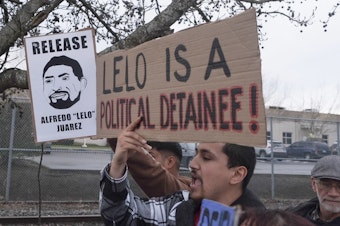 caption: Protesters rally at the Northwest ICE Processing Center in Tacoma on March 27, 2025, following the detention of two local union members.