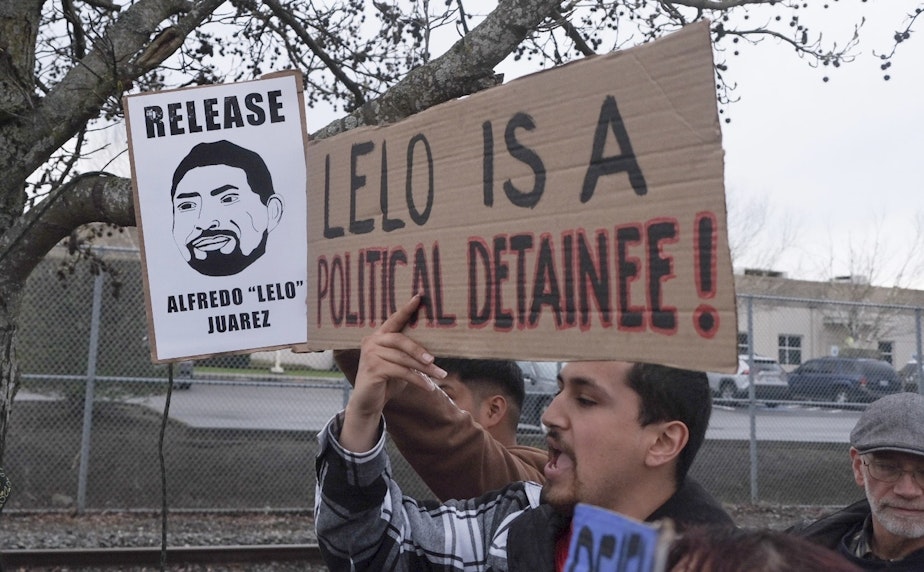 caption: Protesters rally at the Northwest ICE Processing Center in Tacoma on March 27, 2025, following the detention of two local union members.
