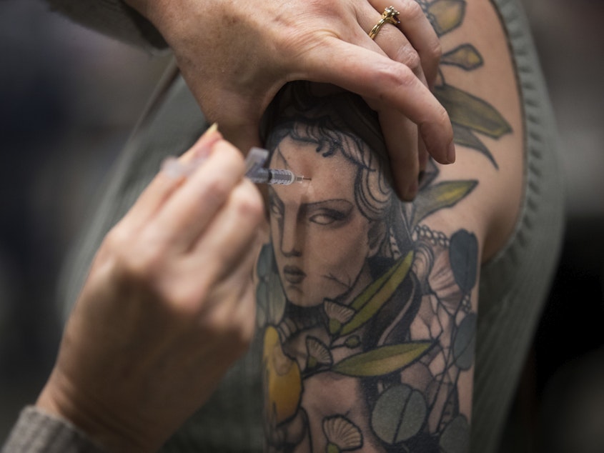 caption: Lauren Alexander is vaccinated against COVID-19 in Seattle on April 15. <a href=blog-pandemic-updates-for-washington-april-12-16__full.html Story</a>