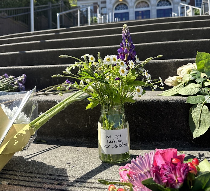 caption: Flowers and candles left on steps of Garfield High School in Seattle, following the fatal shooting of a student on campus June 6, 2024.