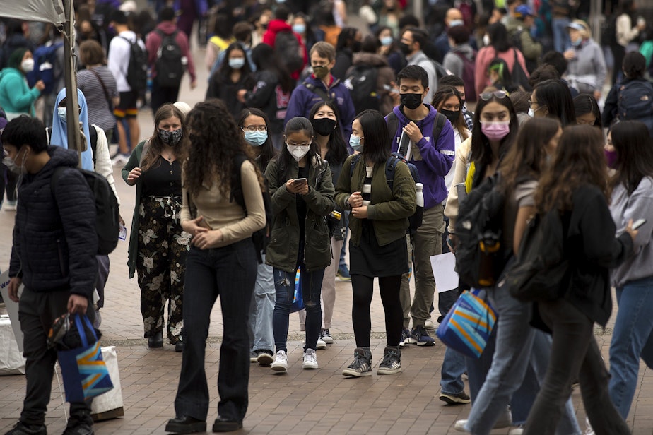 caption: University of Washington students walk through Red Square on the first day of school, on Wednesday, September 29, 2021, in Seattle.