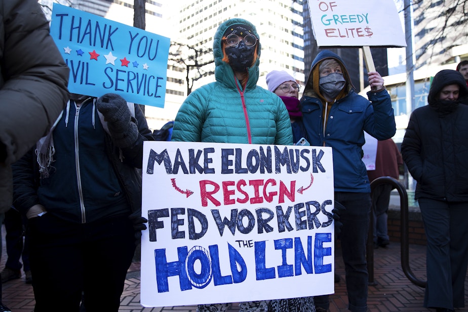 caption: A federal worker with the Environmental Protection Agency joins a rally at the Jackson Federal Building to ‘save civil service’ on Tuesday, February 11, 2025, in Seattle.