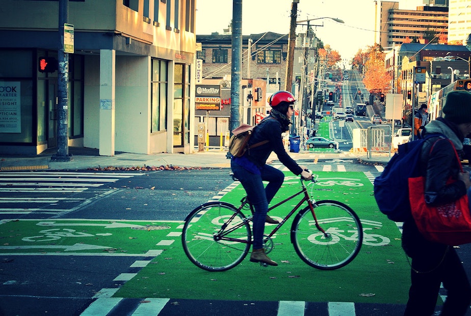caption: A biker rides in a protected lane on Broadway.