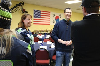 caption: State Sen. Joe Fain (R-Auburn), center, greets supporters at a breakfast campaign event with state Sen. Ann Rivers (R-La Center), left, on Oct. 14, 2018.
