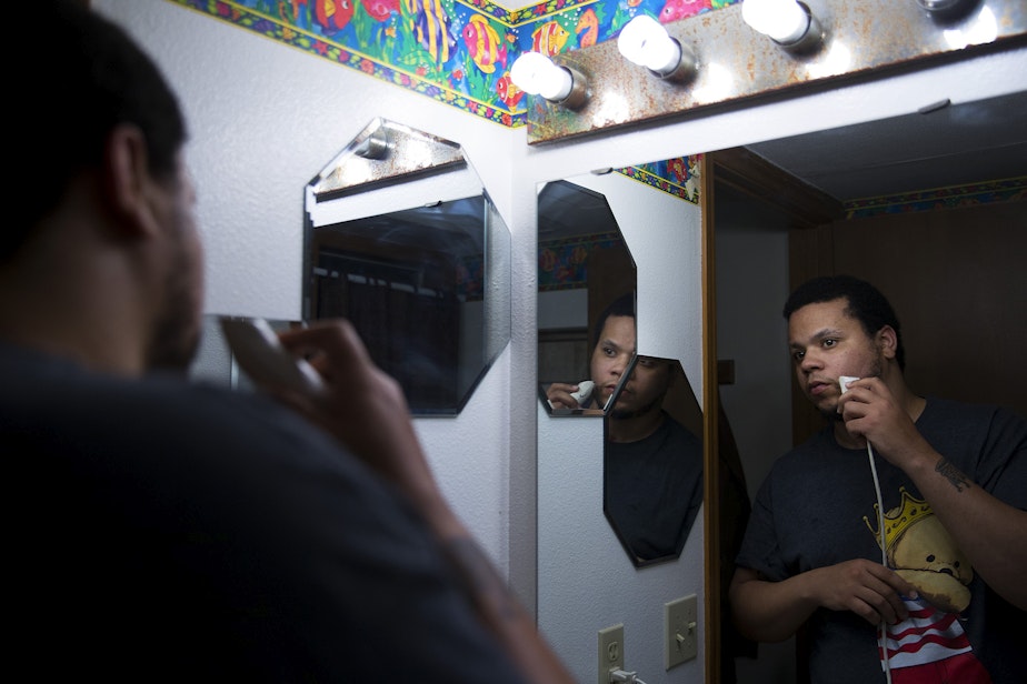 caption: DaShawn Horne looks in the mirror while shaving on Thursday, November 15, 2018, the night before Julian Tuimauga's sentencing, at his home in Auburn.