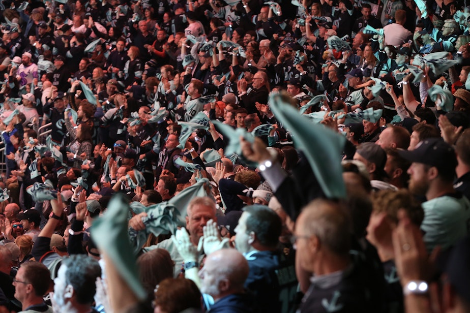 caption: Kraken fans celebrate during a playoff game on April 24th, 2023, at the Climate Pledge Arena in Seattle.