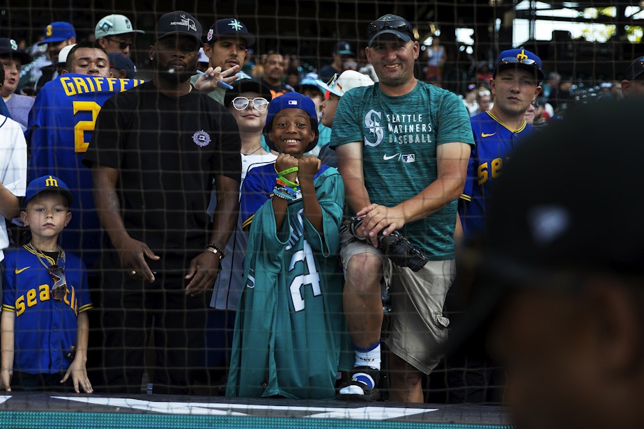 caption: Zayvion Jones, 9, center, reacts while getting his ball signed by a player on Friday, July 7, 2023, before the first ever HBCU Swingman Classic at T-Mobile Park in Seattle.