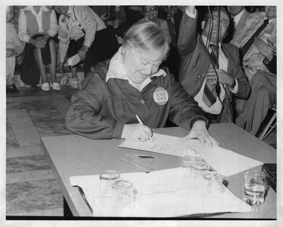 caption: Gov. Dixy Lee Ray, Washington's first female governor, signing a renewal of the Senior Citizens Services Act in May 1979.