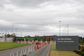 caption: The U.S. - Canada border at Blaine, Wash. The entry is marked by the Peace Arch, a massive arch at the border that states, "Children of a Common Mother." The Peace Arch park spans both sides of the international border. 
