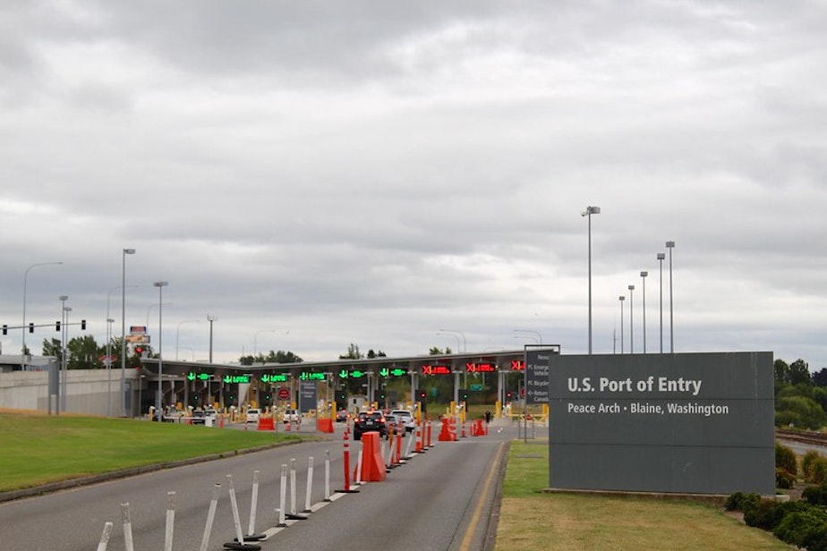 caption: The U.S. - Canada border at Blaine, Wash. The entry is marked by the Peace Arch, a massive arch at the border that states, "Children of a Common Mother." The Peace Arch park spans both sides of the international border.