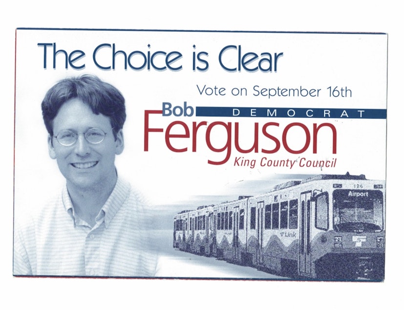 caption: A mailer from Bob Ferguson's primary campaign for county council in 2003. A key part of his criticism of regional light rail was that despite an overspent budget, it did not yet reach Seattle-Tacoma International Airport.
