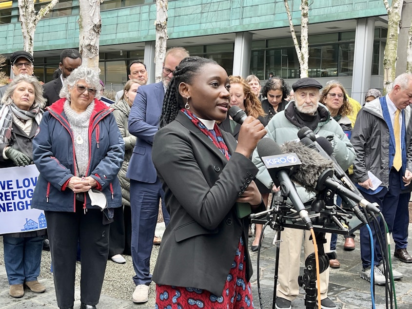 caption: Rev. Emillie Binja celebrate's a judge's ruling against President Donald Trump's refugee ban outside of the U.S. District Court for the Western District of Washington on Tuesday, Feb. 25, 2025. Binja came to the U.S. as a refugee after fleeing the Democratic Republic of Congo at age 8.