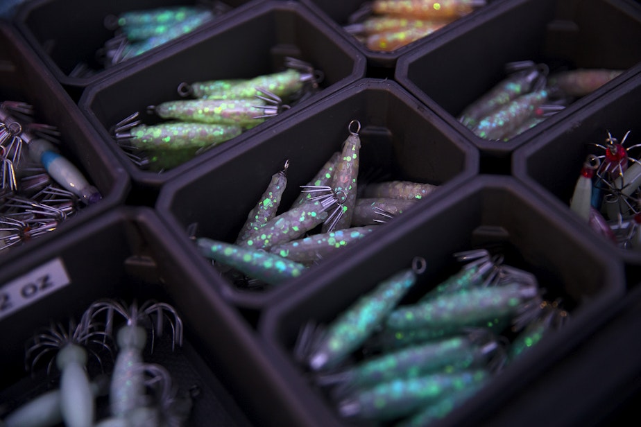 caption: Various glow in the dark jigs for catching squid made by Curtis Alm are shown for sale on Friday, November 17, 2023, at Les Davis Pier in Tacoma.