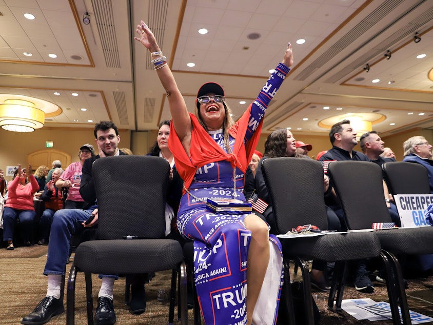 caption: An attendee celebrates live election results during the Washington GOP Election Night watch party on Tuesday, November 5, 2024, at the Hyatt in Bellevue.