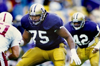 caption: Lincoln Kennedy was a dominant offensive tackle who helped the Washington Huskies to a perfect 12-0 season and a national title in 1991.
