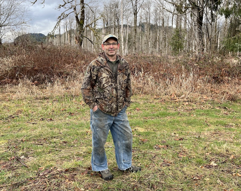 caption: Darrington Mayor Dan Rankin stands near the site of the 2014 Oso landslide.