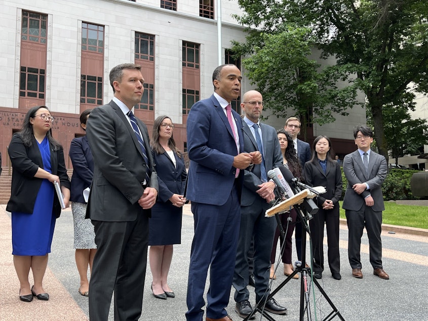 caption: Washington Attorney General Nick Brown outside the Nakamura U.S. Courthouse on June 4, 2023. Solicitor General Noah Purcell, left, and Matt Adams of Northwest Immigrant Rights Project, right, presented oral arguments challenging President Trump's executive order on birthright citizenship before the Ninth Circuit court of appeals.