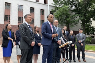 caption: Washington Attorney General Nick Brown outside the Nakamura U.S. Courthouse on June 4, 2023. Solicitor General Noah Purcell, left, and Matt Adams of Northwest Immigrant Rights Project, right, presented oral arguments challenging President Trump's executive order on birthright citizenship before the Ninth Circuit court of appeals. 
